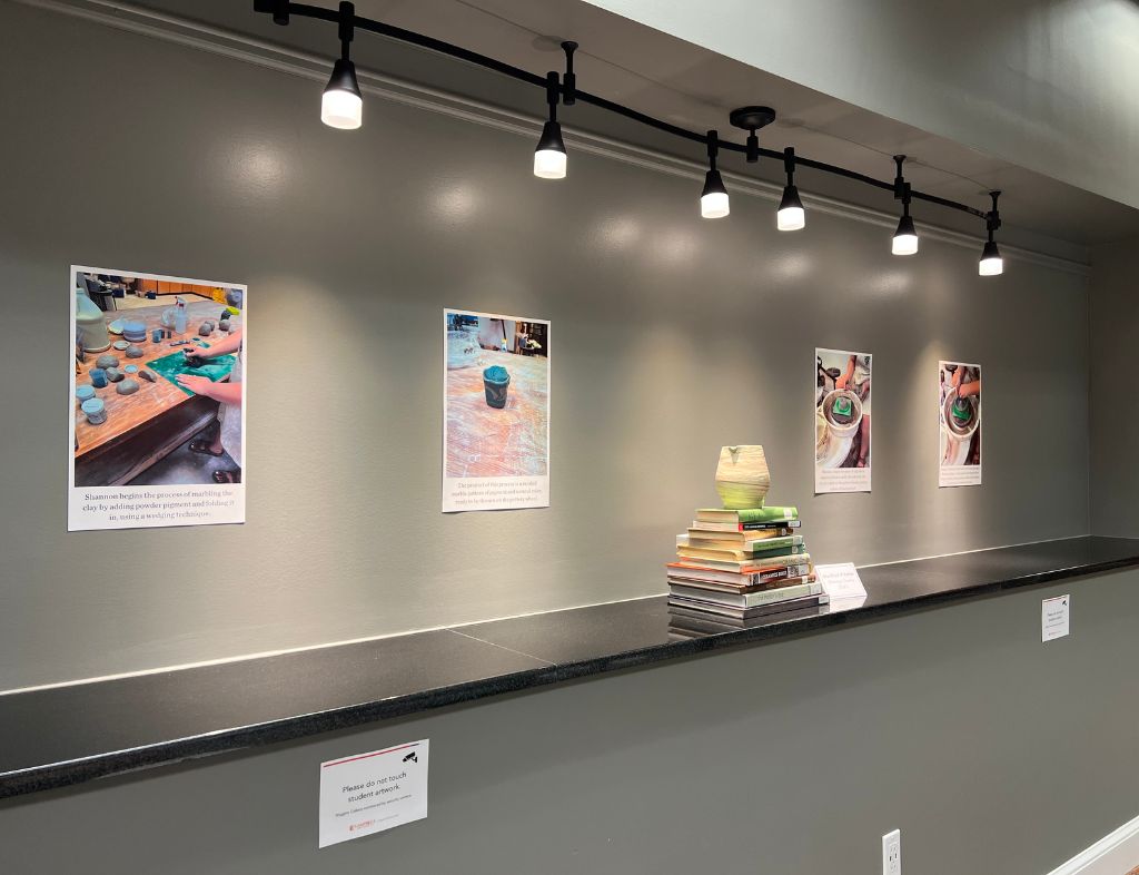 Side view of Shannon Towey Exhibit displaying Marbled Pitcher and the marbling process on the wall behind.